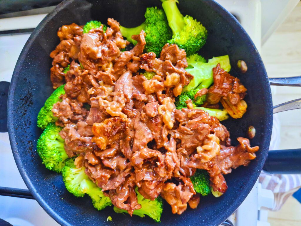 Stir-fried beef over broccoli