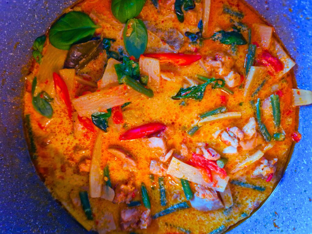 Red curry chicken infused with aromatic spices and coconut milk